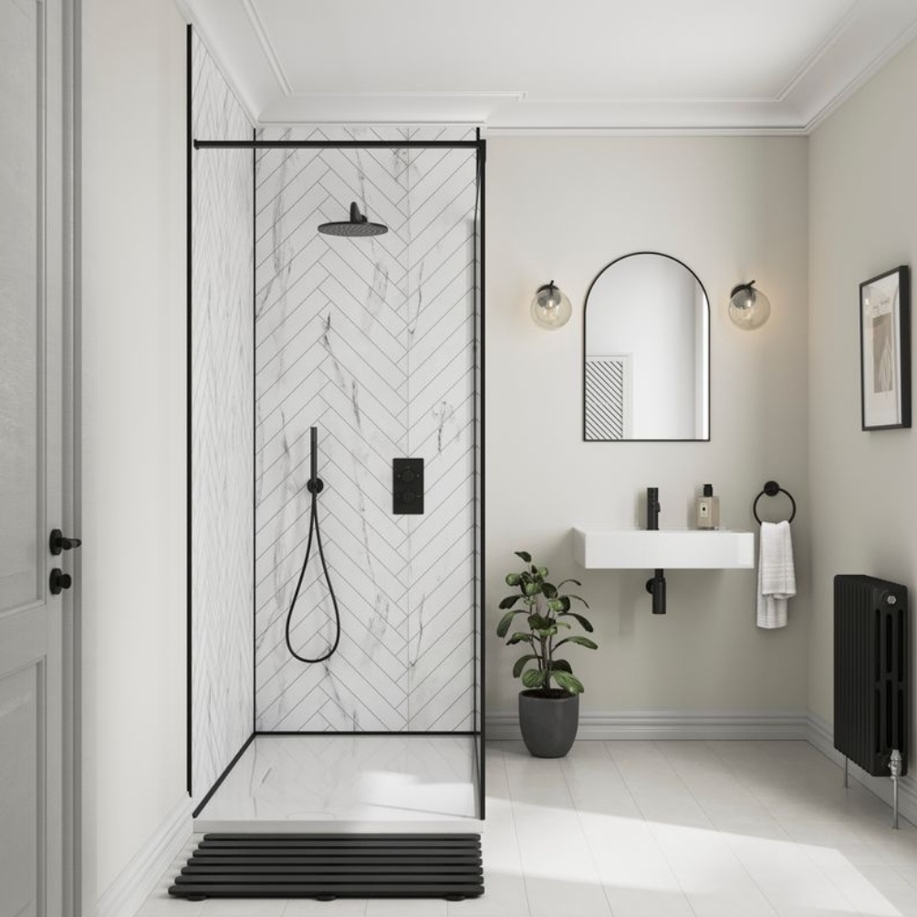 Lifestyle image of the Showerwall Laminate White Marble 2400mm x 600mm Herringbone Tile Effect Wall Panel - SWT03 installed in a walk-in shower enclosure